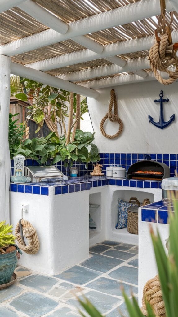 Coastal outdoor kitchen with white and blue accents and seafood grill.