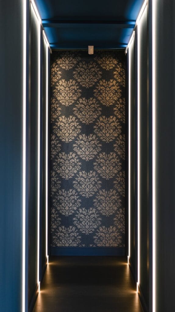 A hallway with bold dark blue walls and stylish wallpaper.